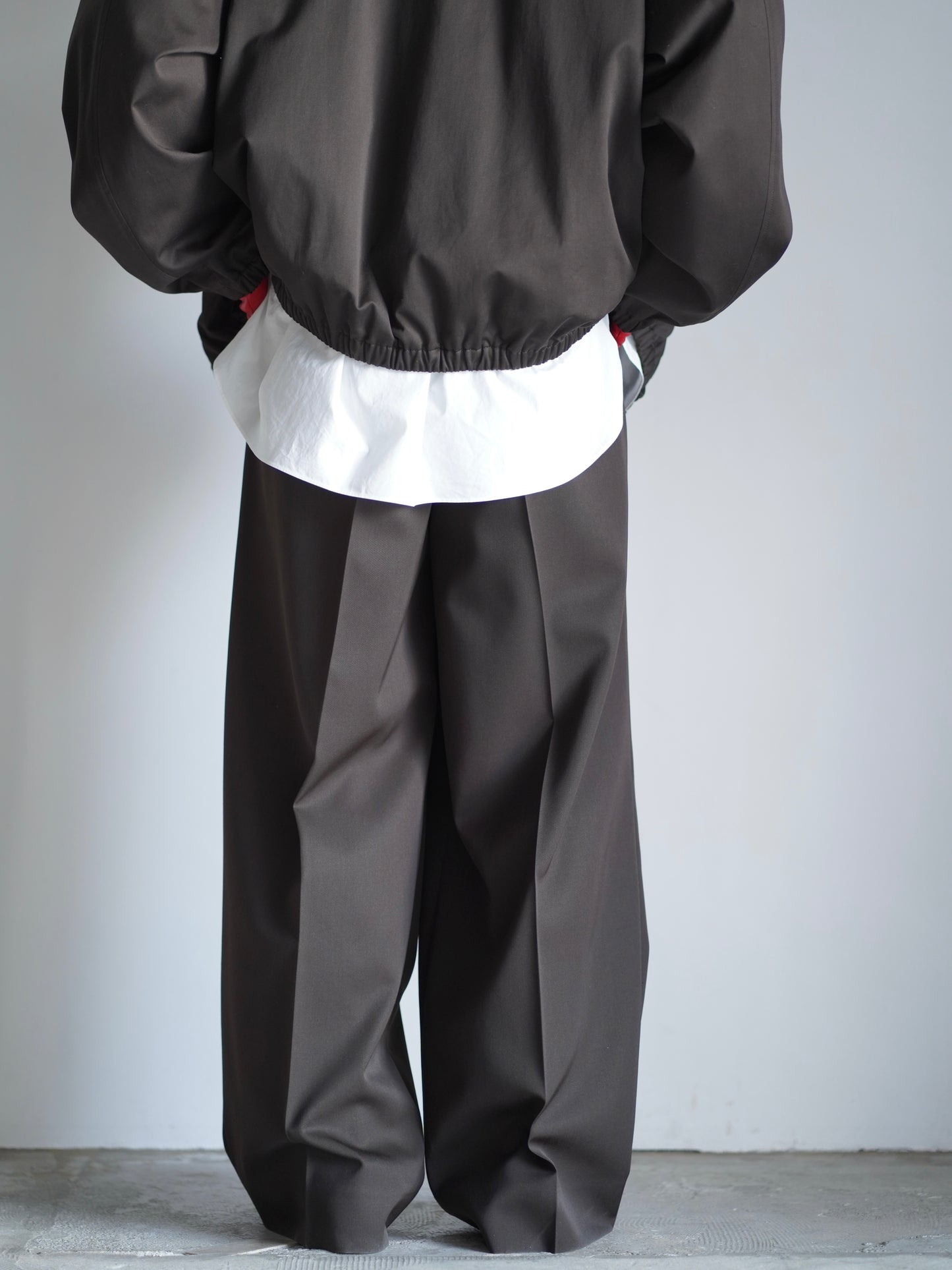 sssteinのLONG WIDE TROUSERSのカラーはDARK BROWEの後向きの着用画像です。こちらの商品は通信販売で購入可能です。